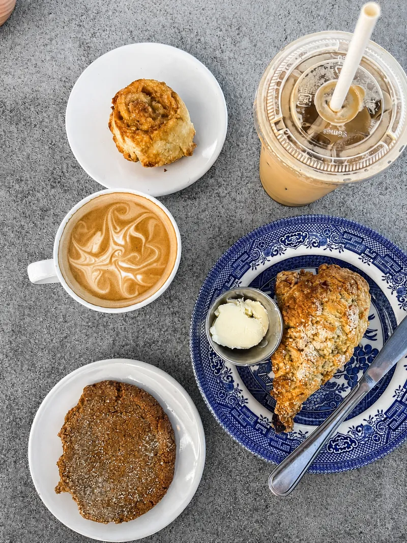 Coffee, an iced drink and baked treats on a table at Cottage Cafe.